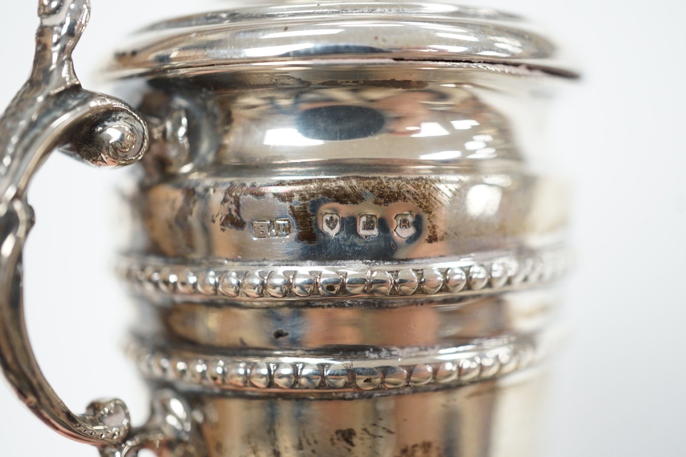 A miniature George V Scottish silver lidded trophy cup, on stand, Edinburgh, 1913, overall 14cm and a George V silver navette shaped dish.